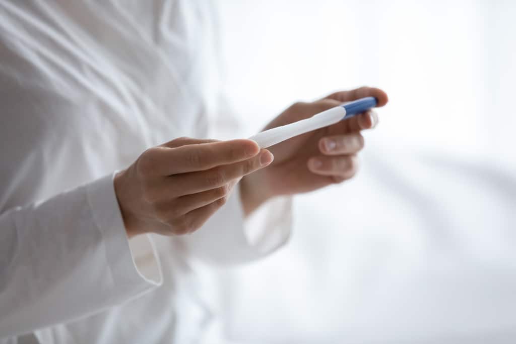 Close up of woman holding ovulation pregnancy test